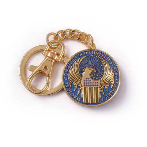 Porte-clés Macusa - Animaux Fantastiques en métal doré et bleu, emblème du Congrès Magique des États-Unis d'Amérique, accessoire incontournable pour les fans des films Fantastic Beasts.