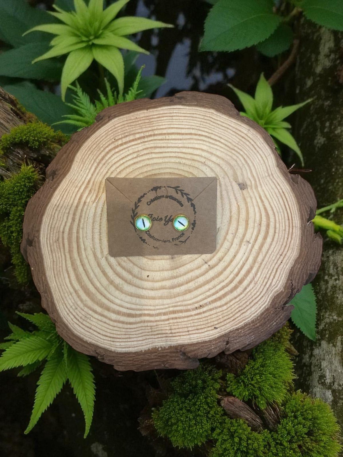 Boucles d'oreille œil de dragon élégantes de Jessica Deelyah, faites main avec de l'acier inoxydable et de l'argile polymère, embellies de feuilles d'or et de paillettes.