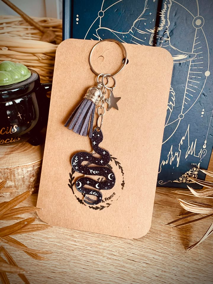 Détail du porte-clés Serpent mystique avec pompon en simili cuir, mettant en valeur son design unique et captivant.