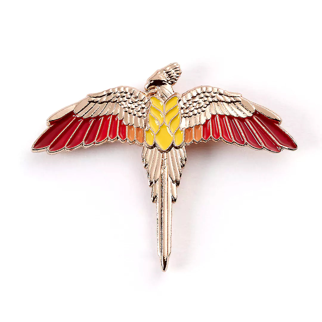 Pin’s Fumseck plaqué or rose - Harry Potter, un bijou emblématique de la saga, représentant le fidèle oiseau de Dumbledore. Élégant et magique, à porter sur vêtements ou accessoires.
