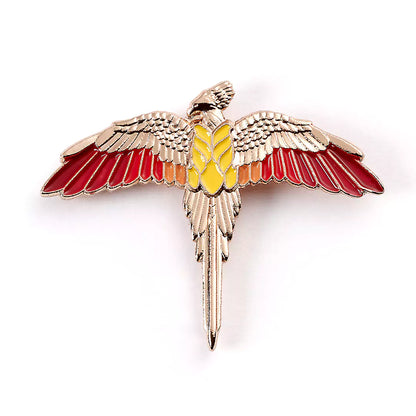 Pin’s Fumseck plaqué or rose - Harry Potter, un bijou emblématique de la saga, représentant le fidèle oiseau de Dumbledore. Élégant et magique, à porter sur vêtements ou accessoires.