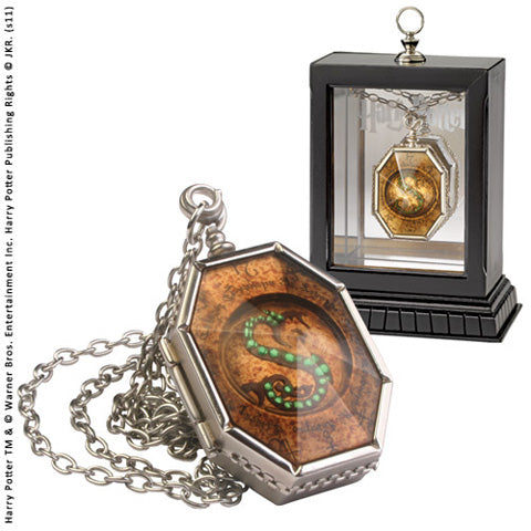 Médaillon de Salazar Serpentard, Horcruxe emblématique de Harry Potter, en laiton plaqué argent, présenté dans une boîte de collection.
