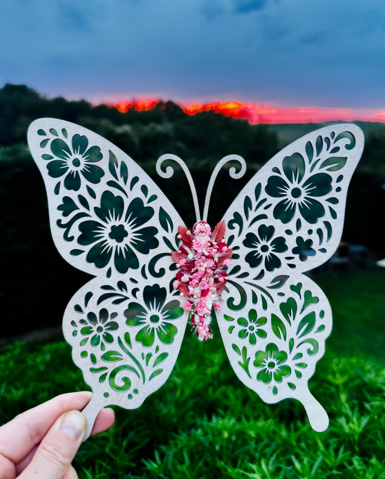 Papillon en bois avec une aile recouverte de fleurs séchées de L'atelier Bcréa, une œuvre artisanale unique qui apporte une touche de poésie à votre décoration.