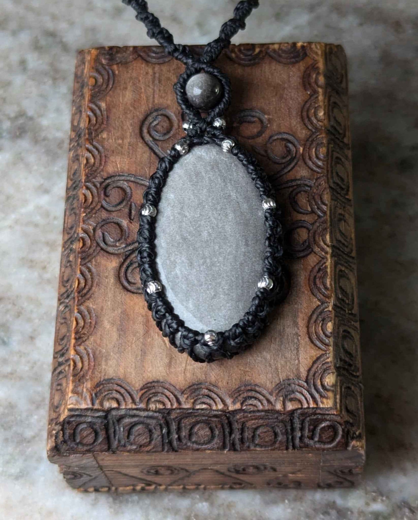 Collier noir avec obsidienne argentée de Les fils ensorcelés, un bijou conçu à la main qui évoque mystère et élégance, parfait pour sublimer n'importe quelle tenue.